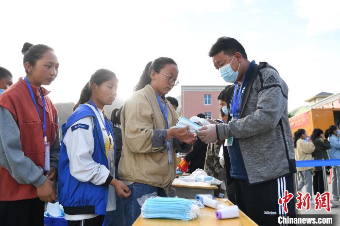 7月7日，考生在拉薩三高考點外領(lǐng)取口罩?！『闻罾?攝